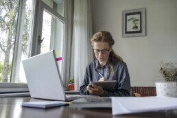 Woman doing family history research on a laptop.