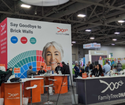 A vibrant scene at the FamilyTreeDNA booth at RootsTech 2025, where attendees engage with DNA testing experts and explore genetic genealogy resources.