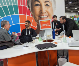 FamilyTreeDNA team members engaging in a 15-minute consultation with a RootsTech attendee, providing insights on DNA testing and family history research.