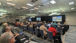 Attendees at the 2023 International Conference on Genetic Genealogy listen to a keynote presentation.